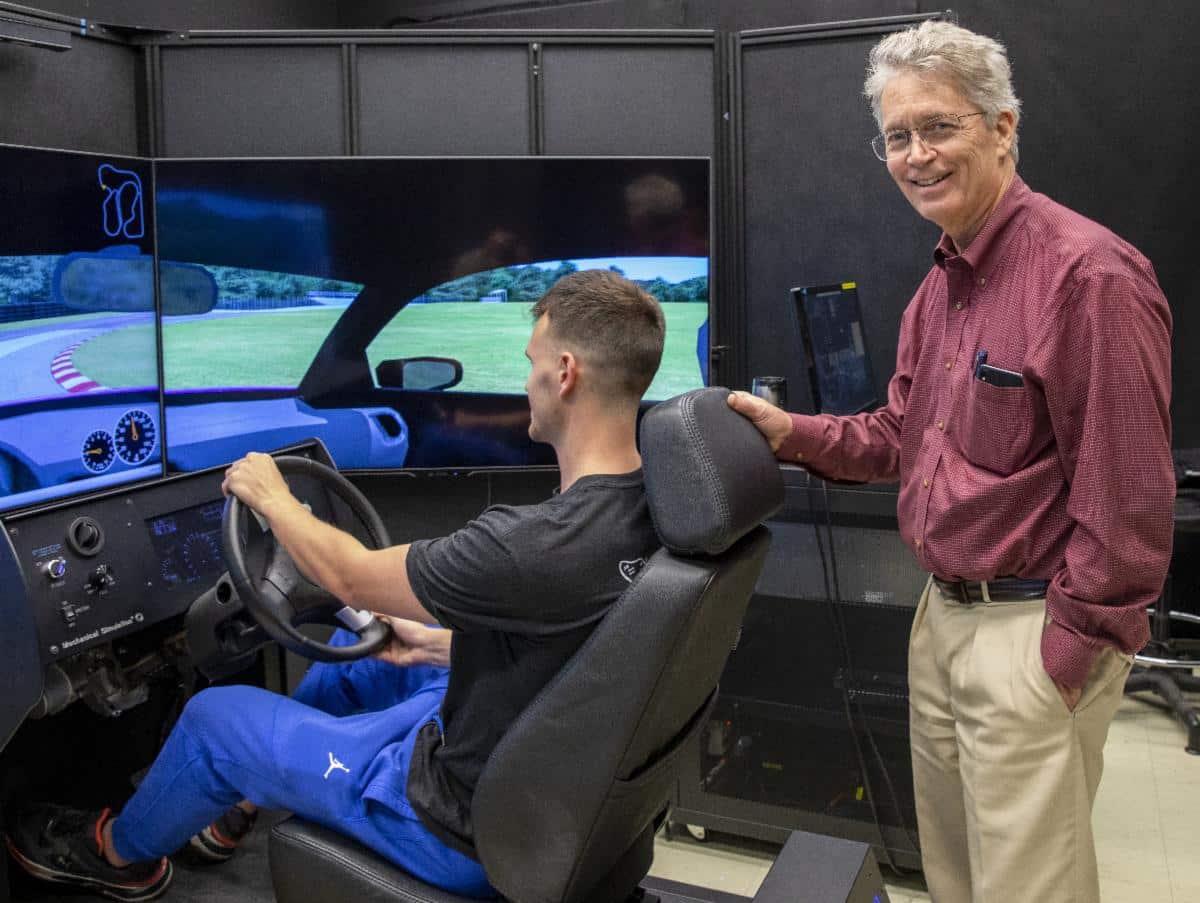Art Hyde and an Automotive Student using an Automotive Simulator
